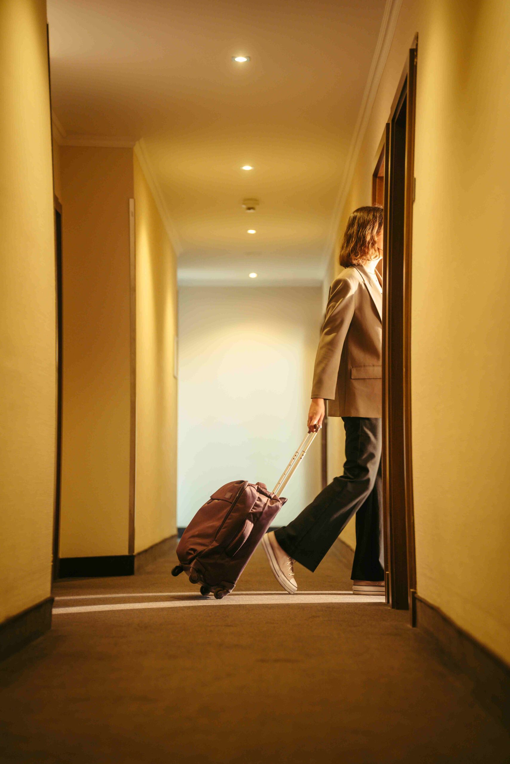 A person with a trolly walking into a hotel room at a flemings hotel