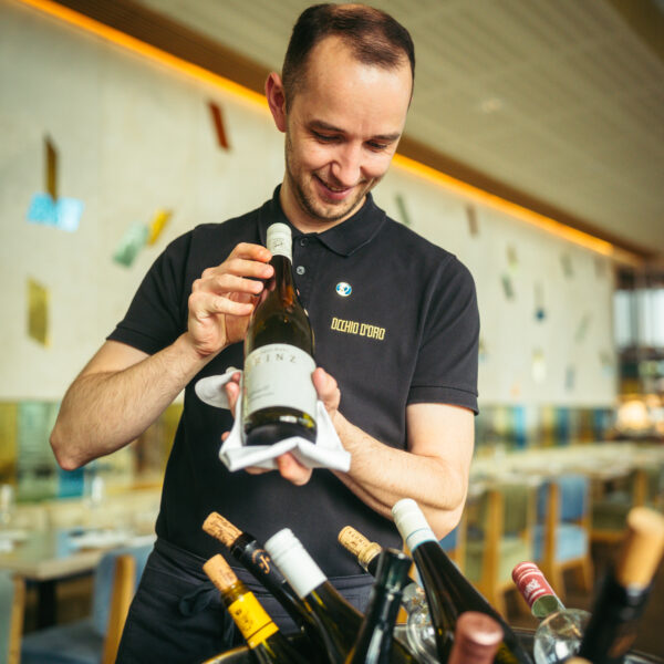 A waiter serving wine at Cuchina da Nina by Flemings hotels