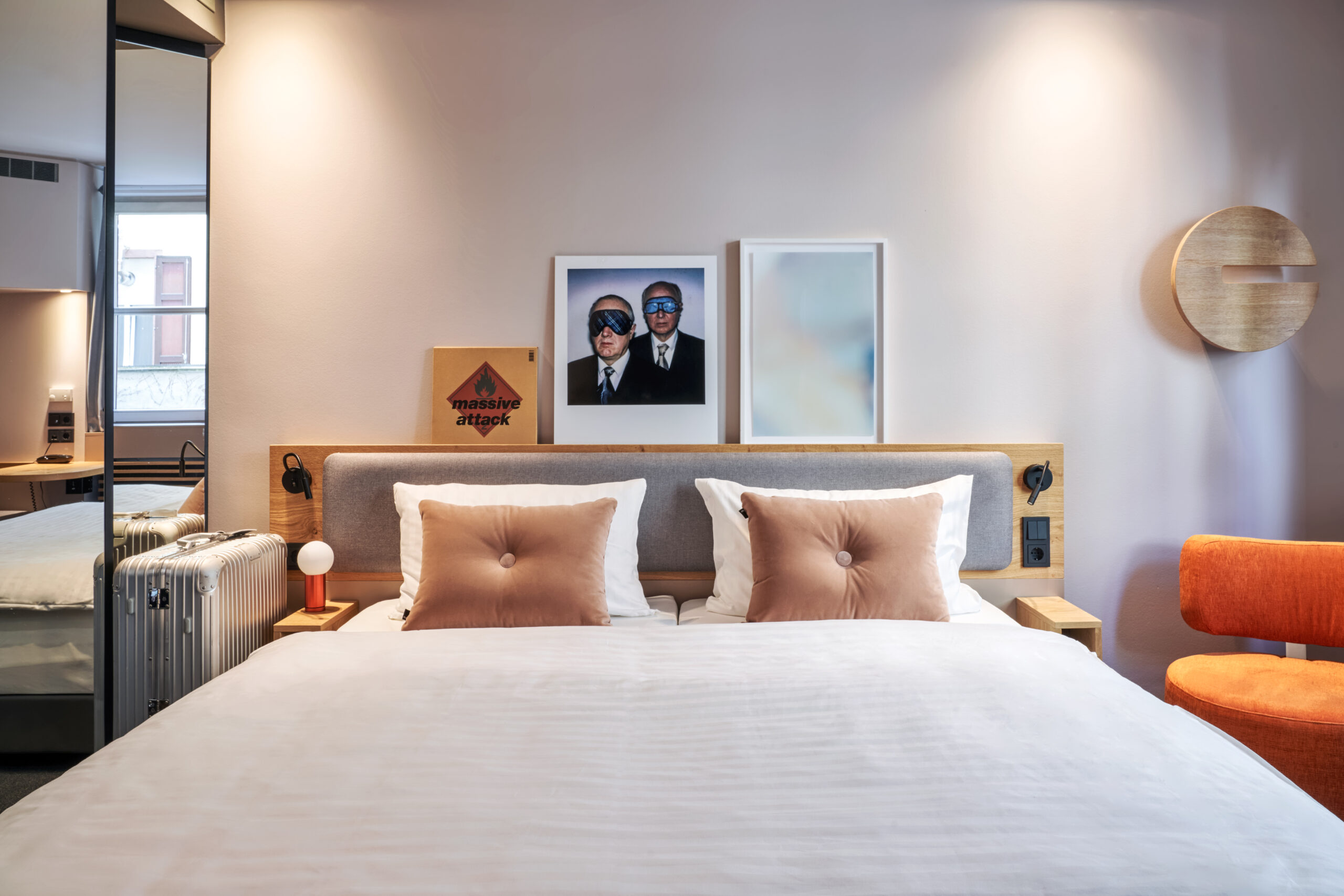 Double bed in a Fleming's hotel with pictures and paintings