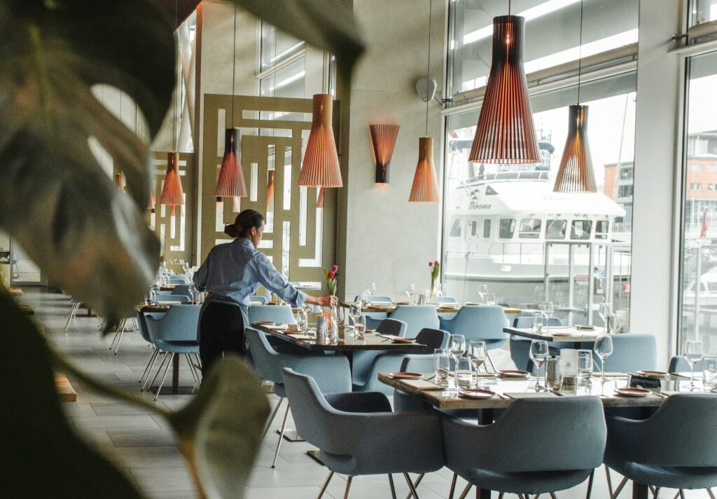Woman in restaurant setting the table